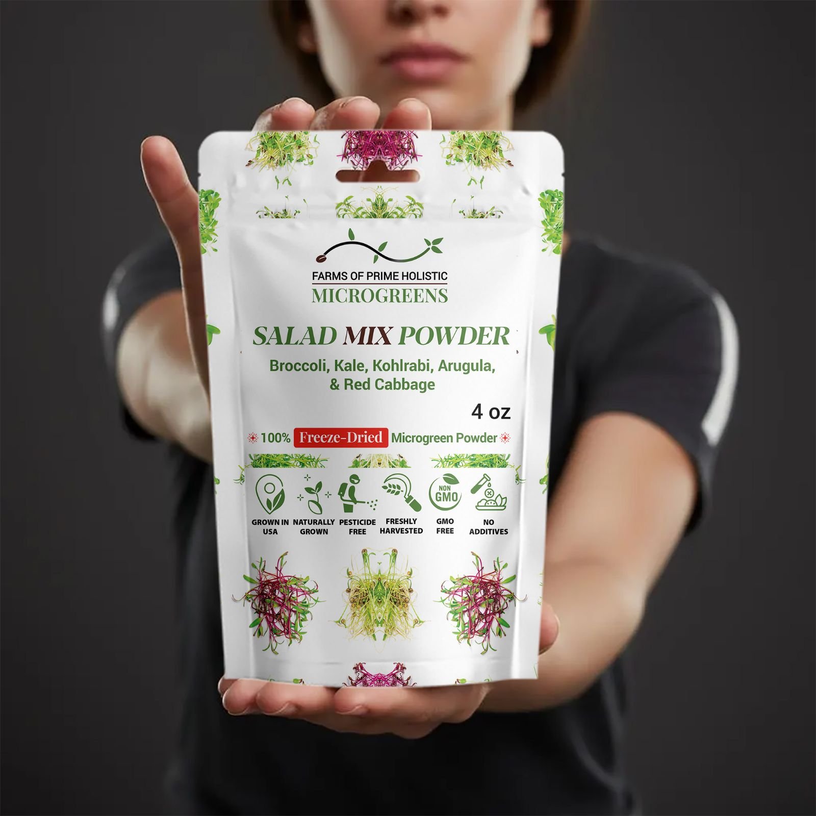 A person holds a white package of "Salad Mix Powder" with green text. It features microgreens illustrations and highlights being freeze-dried and GMO-free.